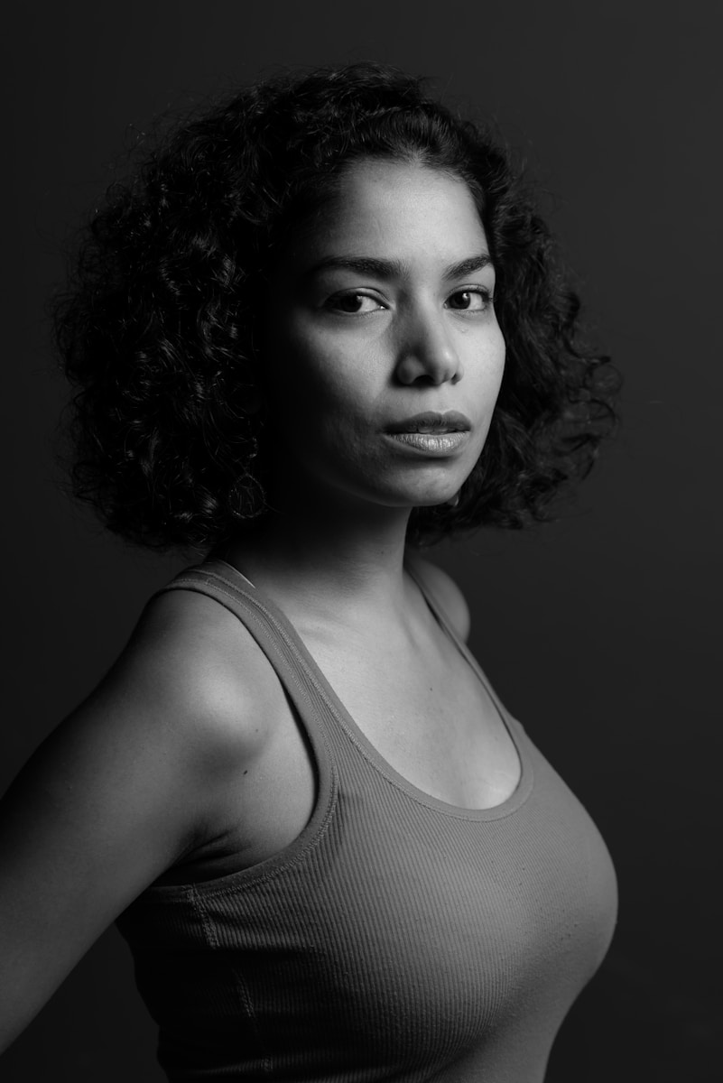a black and white photo of a woman with curly hair