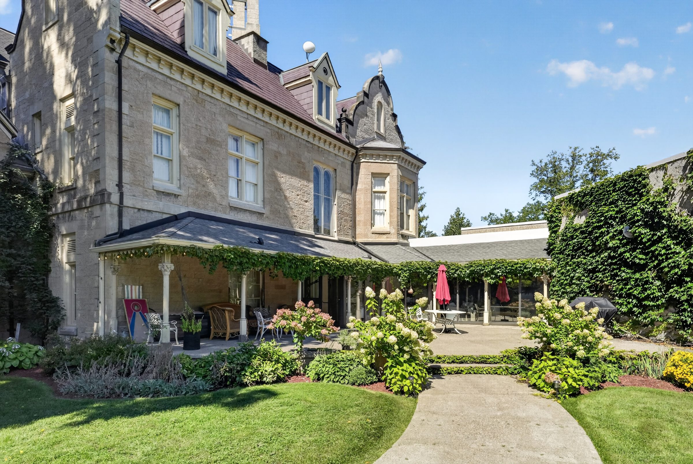The garden side of Rodman Hall, with the veranda and lawn