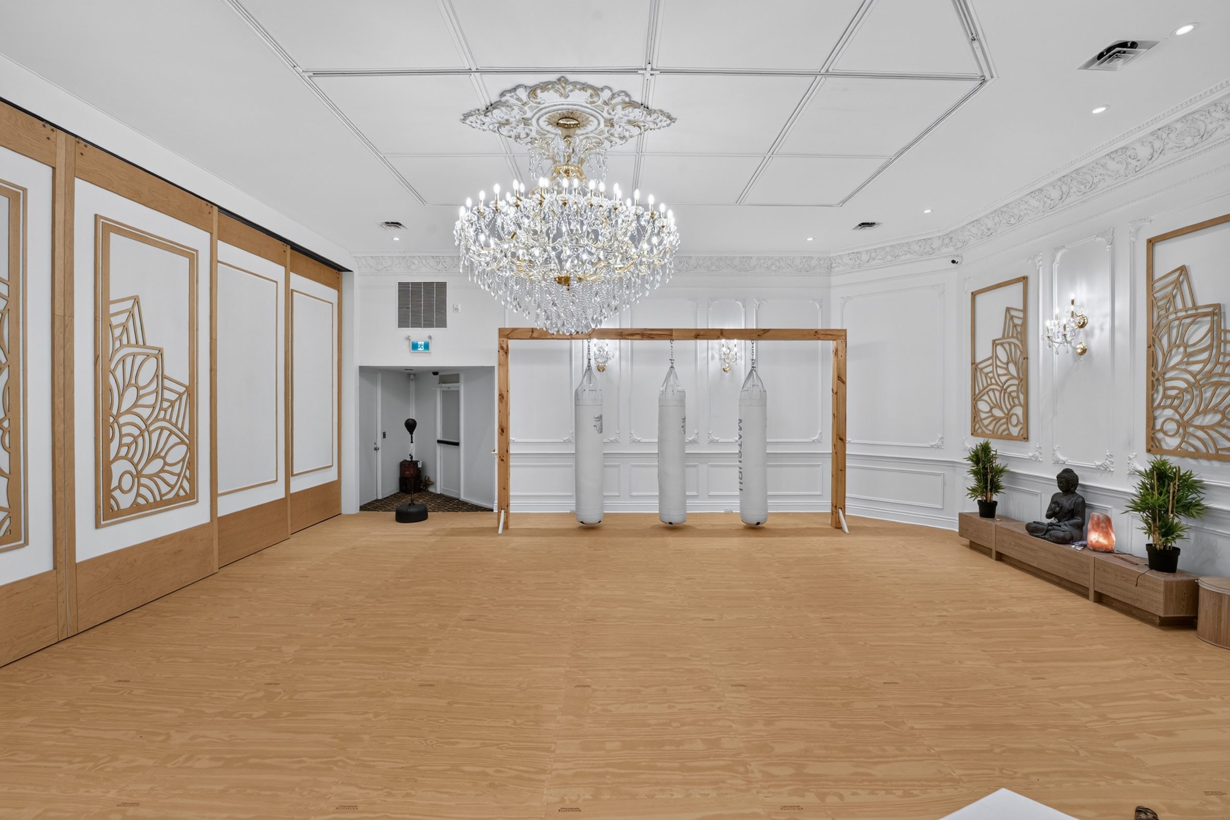The studio at Rodman Hall, with heavy bags on a freestanding rack and open floor space